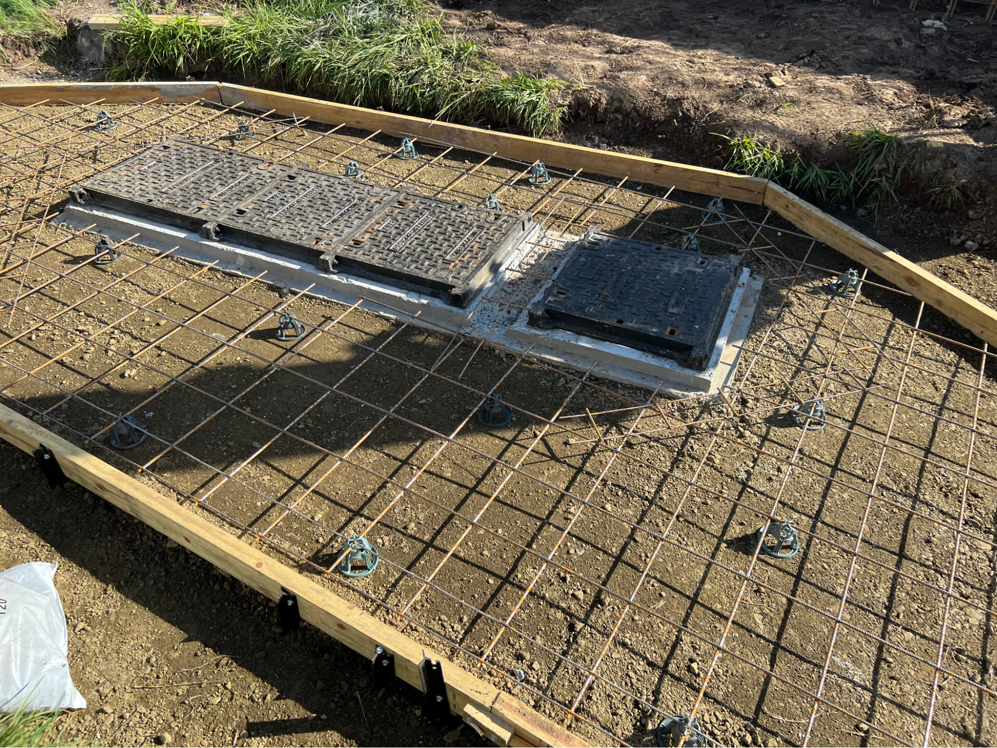 Reinforcement mesh and access covers set before the pour