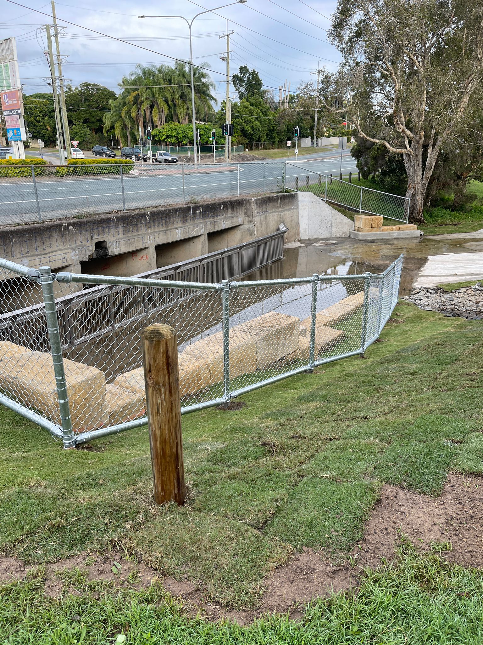 Completed channel, chain-mesh fence and sandstone blocks